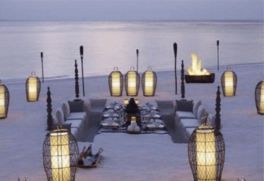 sunken beach picnic with cadle lanterns in paper and wire mesh cases