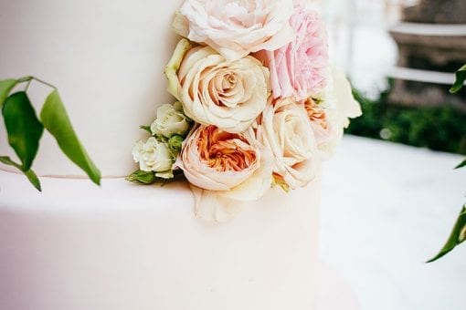 Pink ombre tiered luxury wedding cake decorated with pastel roses