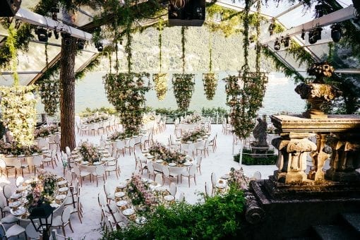 Luxury destination wedding with floral chandelier under a bespoke clear marquee at Villa Pizzo, Lake Como