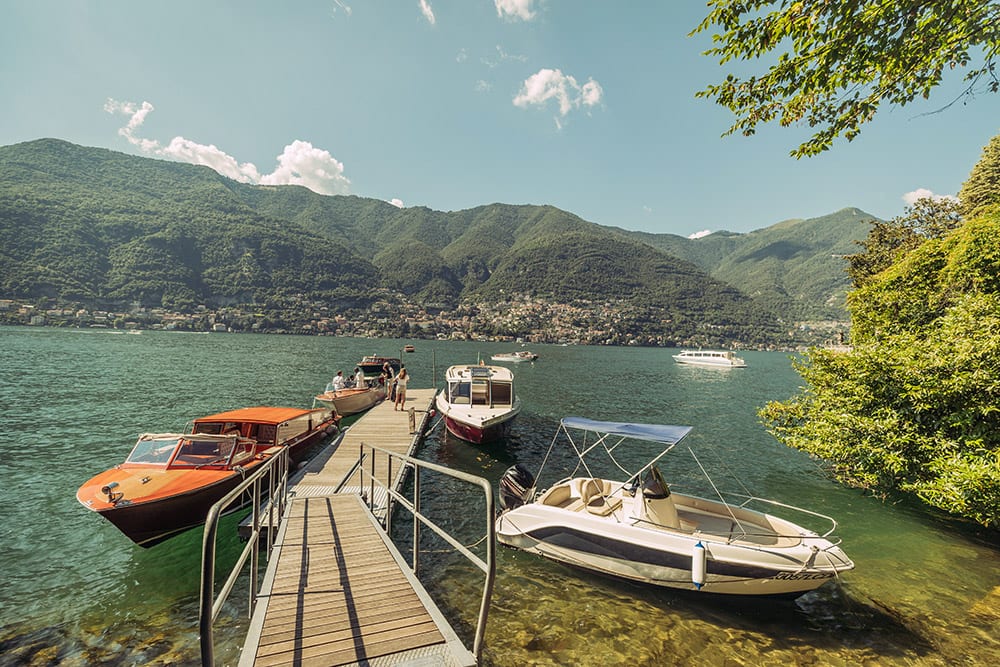 Jetty at Casta Diva with venetian style boats perfect to transport the bridal party to their wedding in Lake Como