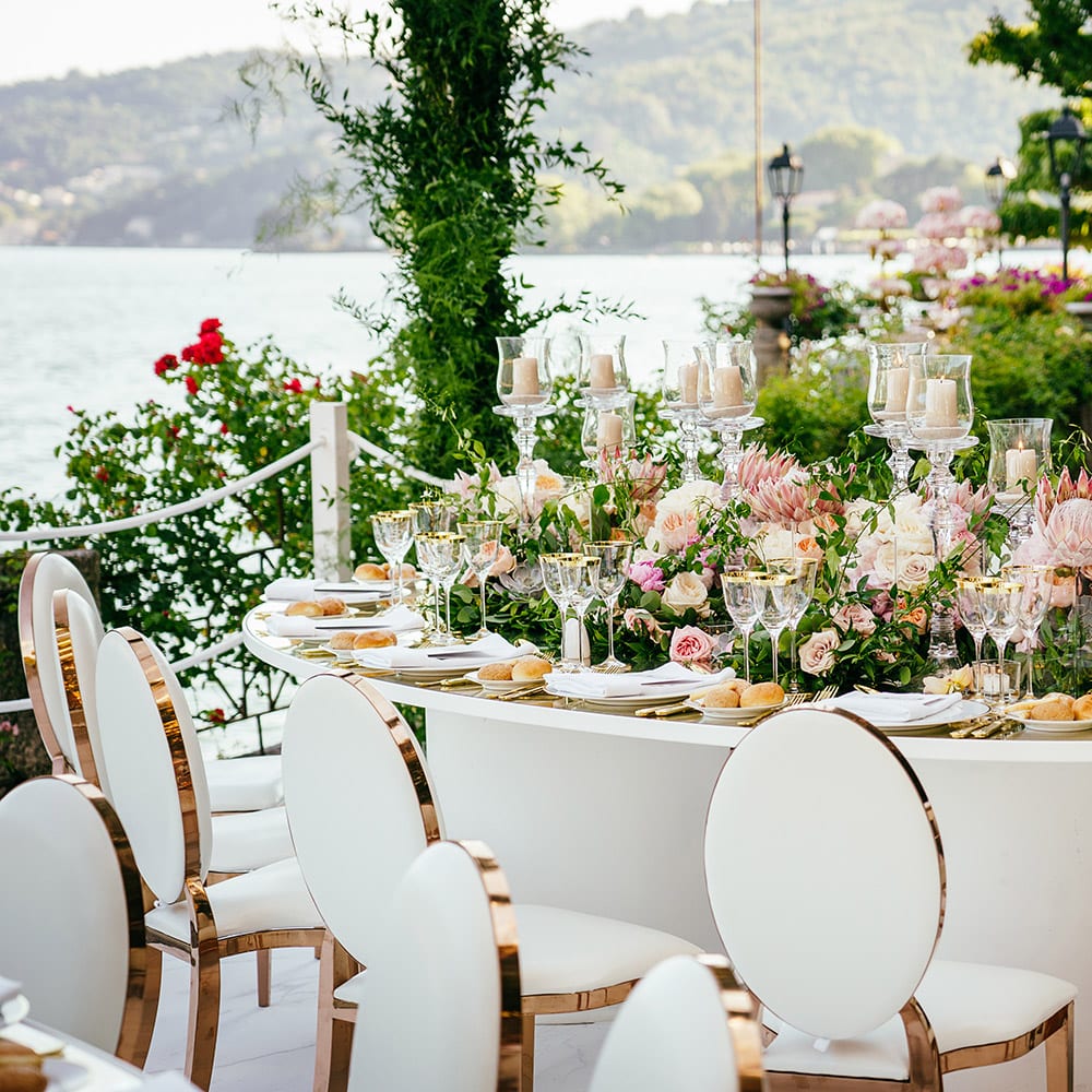 Outdoor white cloth wedding table set with flowers and candles