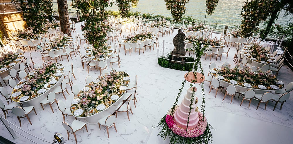 Wedding tables set for dinner and decorated with fresh flowers and candles