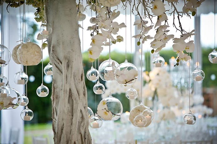 Silver baubles hanging from a decorative tree