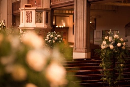 Beautiful rose and flower pew arrangements at a Chelsea church in London
