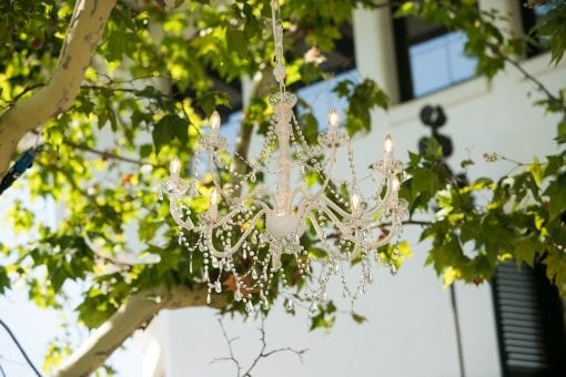 Stunning crystal chandelier hanging from trees for a luxury wedding ceremony in Barcelona, Spain