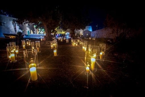 An abundance of candles lighting the pathways at a luxury wedding reception in Santorini