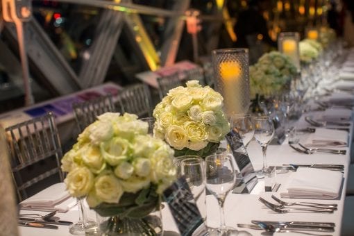 Cream rose vases set at Tower Bridge for a private luxury birthday party