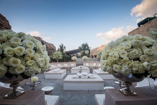Luxury destination wedding in Santorini with white roses, hydrangeas and hand built soft seating