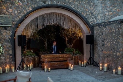 Pianist and singer performing at a wedding reception surrounded by twinkly lights and candles at a luxury destination wedding