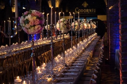 Long tables filled with thousands of candles and flowers at a luxury destination wedding in Barcelona, Spain