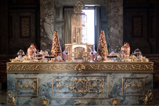 Bespoke dessert station full of cakes and sweets on top of an intricately designed counter for a luxurious wedding at Blenheim Palace