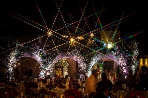 World class luxury destination wedding reception in Santorini, Greece full of opulent floral designs