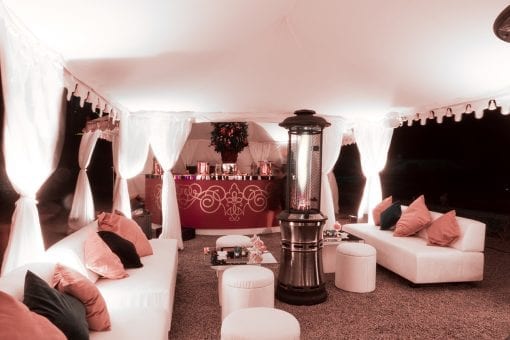 Luxury wedding on the Water Terrace at Blenheim Palace with a beautiful Raj tent with pretty white draping, soft seating and wow bespoke bar