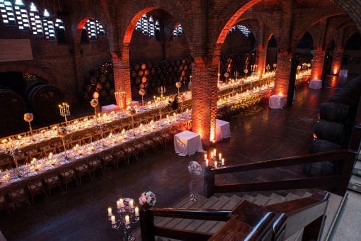 Stunning shot of a luxury destination wedding reception set for dinner with such a beautiful lighting design