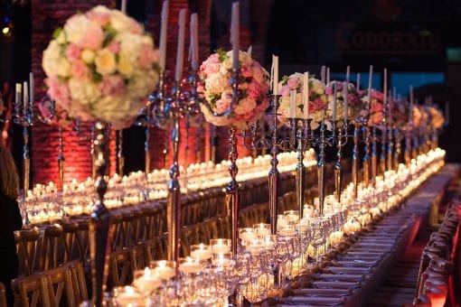 Lavish long tables with tall candelabras and florals for a luxury destination wedding in Barcelona