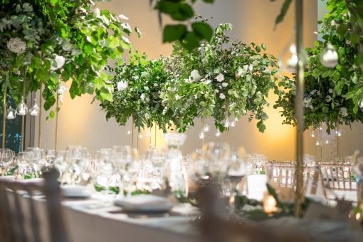 Incredible floral arrangements with handing trees at high end wedding venue in London, UK