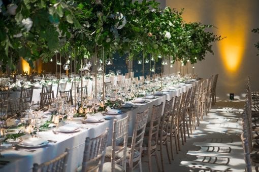 Stunning wedding reception styled with green foliage and romantic lighting at a luxury wedding in London