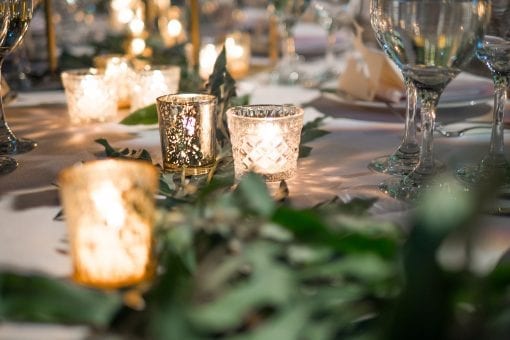 Organically styled wedding with candle lit table at luxurious wedding reception in London