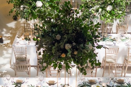 Stunning organic and natural tablescape with green trees in a London venue for a celebrity wedding