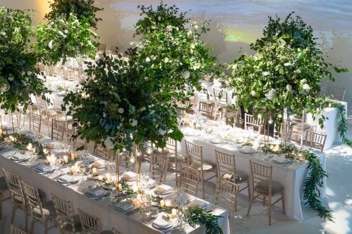 Beautiful tablescape with green trees and foliage table runner for a celebrity wedding in London