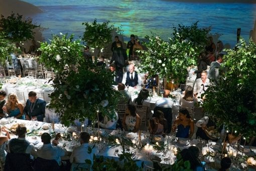 Beautiful celebrity wedding tablescape full of green foliage and Ibiza sunset backdrop at a wedding venue in London