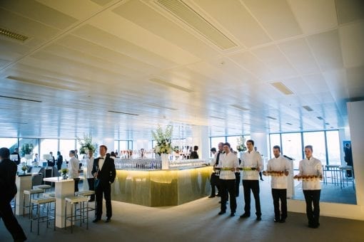 Waiters holding drinks in a room designed specially for a corporate event at the Heron Tower