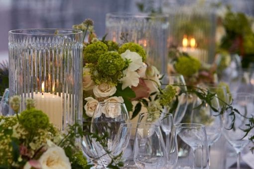 Beautiful cream and pink rose floral centrepiece with crystal vases at a luxurious wedding reception at Blenheim Palace