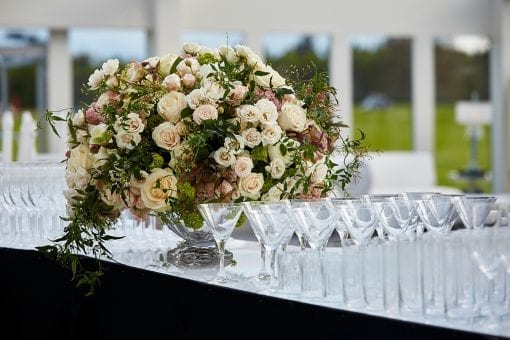 A stunning flower arrangement for a bespoke bar within a glass structure at Blenheim Palace
