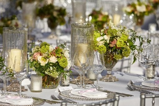 Pretty tablescape with organic florals and crystal candle vases at Blenheim Palace for a lavish wedding