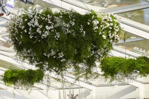 Opulent and elegant floral hanging chandeliers in a world class glass marquee for a luxury wedding at Blenheim Palace