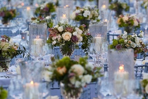 Stunning wedding reception with blush and white rose centrepieces and candles at luxury wedding at Blenheim Palace