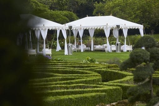 Beautiful and elegant white Raj tents set on a private estate ready for a wedding drinks reception