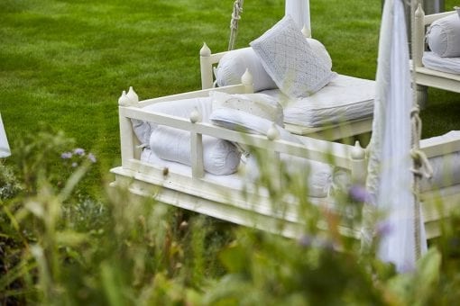 Soft white seating for a drinks reception at a high end private wedding