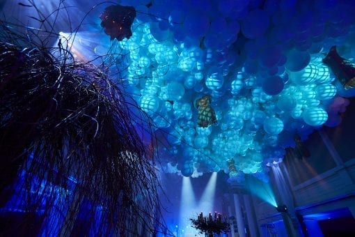 A surreal ceiling with handing dresses and a balloon cloud at One Marylebone