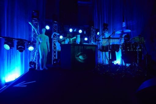 Set design for a bespoke DJ booth and stage for a birthday party with draping