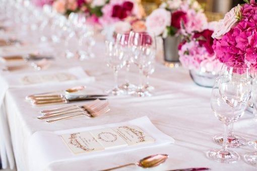 Pretty tablescape with bespoke gold menus on a pink and red floral styled table at the Little Banqueting House for a luxury private party