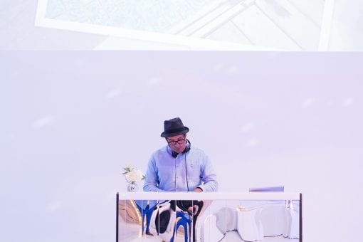 DJ Matt Maurice playing behind a bespoke mirrored DJ both at a luxury wedding after party in London, UK