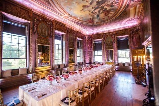Beautiful table set for a private luxury lunch at the Little Banqueting House at Hampton Court Palace with beautiful pink and peach flowers