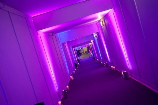Bright pink lighting design for a guest entrance at an event at the Battersea Power Station