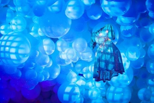 Stunning ballon ceiling design with hanging fashion designs for a Surrealist themed party