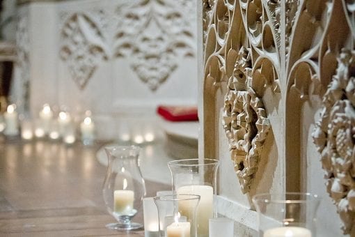 Beautiful wedding ceremony flowers and candles on the floor in Chelsea, London