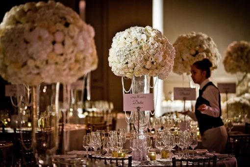 Nigerian white wedding reception with large opulent white floral centrepieces