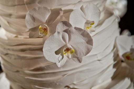 Beautiful white wedding cake with orchids for a Nigerian white wedding in London