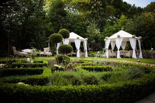 Elegant and pretty Raj tents with white draping in a private estate for a high end party