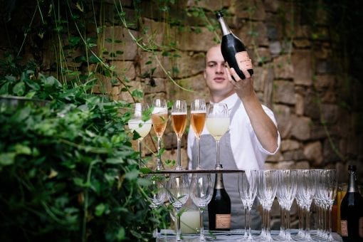 Waiter serving Laurent Perrier Rose champagne at a private London event