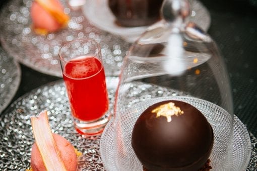 Impressive plated chocolate dessert with glass cloche