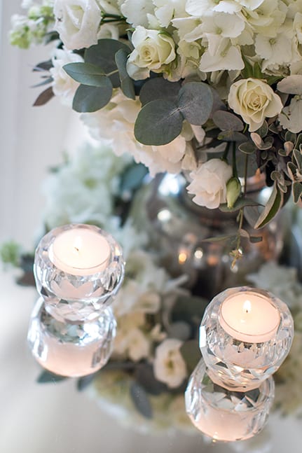 Luxury white wedding, with tablescape detail, in London, with roses, eucalyptus, glass and crystal