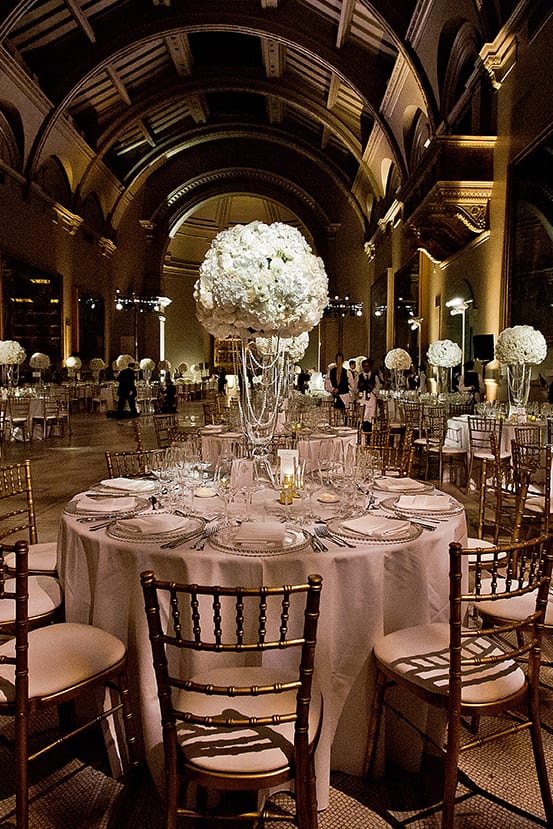 Elegant dinner table prepared for a Nigerian Royal white wedding in the Ralphael Gallery at the Victoria and Albert Museum