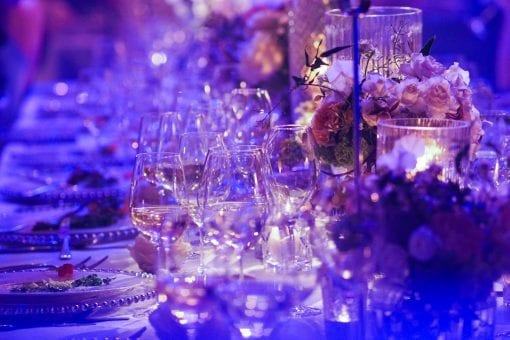 Stunning tablescape with charger plates, glassware and crystal detailing, rose floral table display for luxury wedding reception at Blenheim Palace England