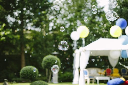 White Raj structures with large balloons and bubbles for a luxury kids party in London
